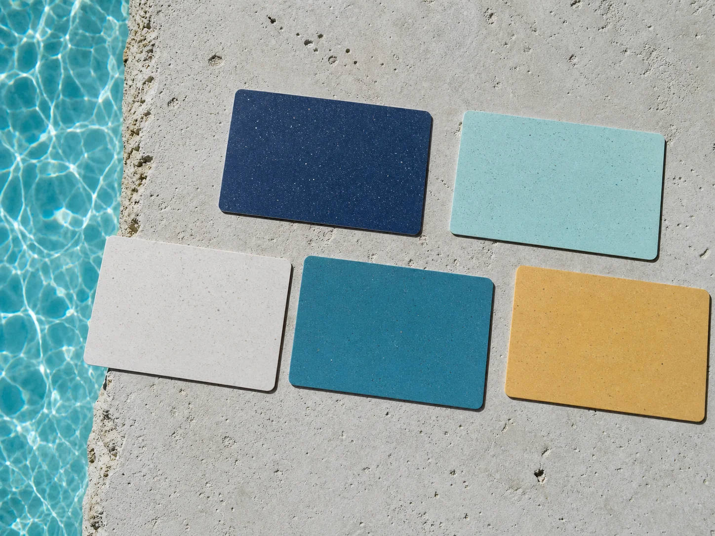 Five recycled-PVC hotel key-card colour directions on pale stone